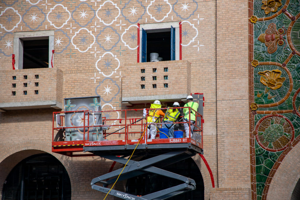 Picture of painters working on stencils in downtown San Antonio, Texas.