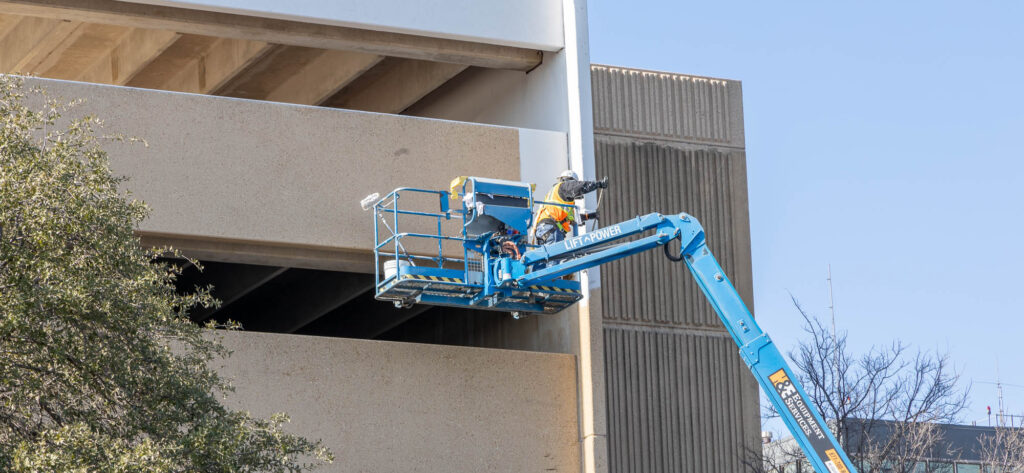 MHST Garage Before Image showing a Travis Painter working.
